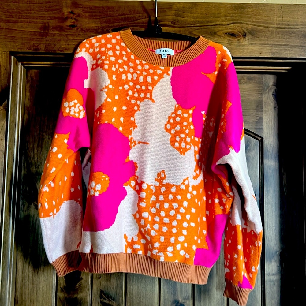 Abstract sweater. Hits above the waist